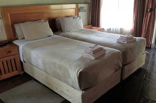 Two single beds in a bungalow.
